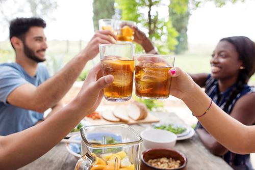 Friends toasting with iced tea