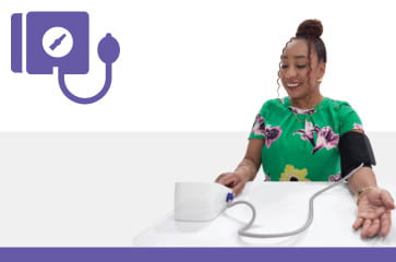 Woman taking her blood pressure at home