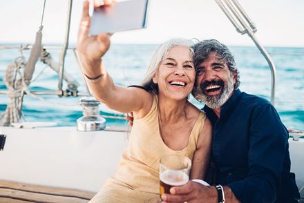 happy couple on sailboat taking selfie happy couple on sailboat taking selfie