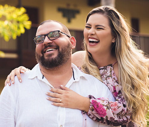stock photo of man and woman hugging and smiling for camera