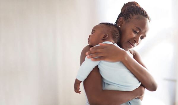 mother holding sleeping infant mother holding sleeping infant