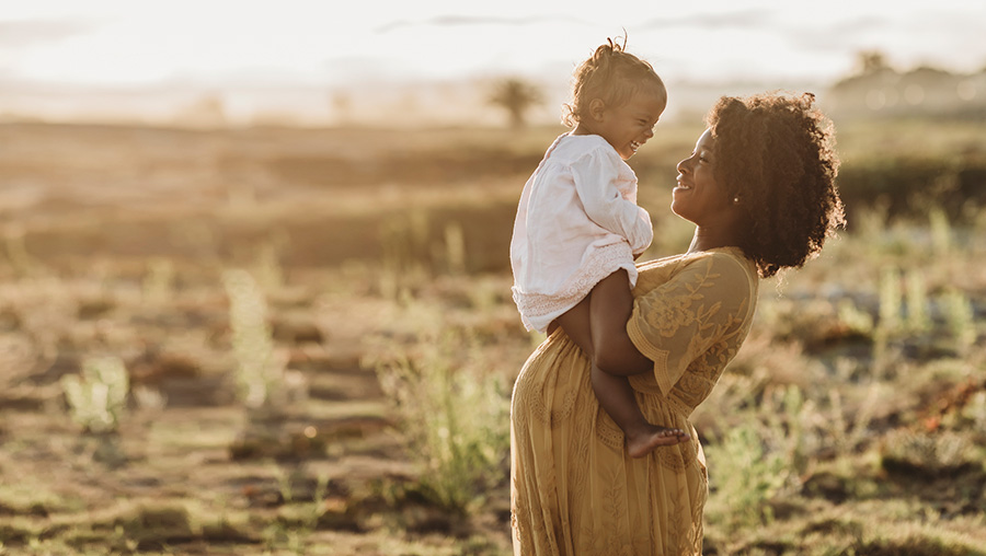 pregnant mother and child in sunset p[regnant mother and child in sunset